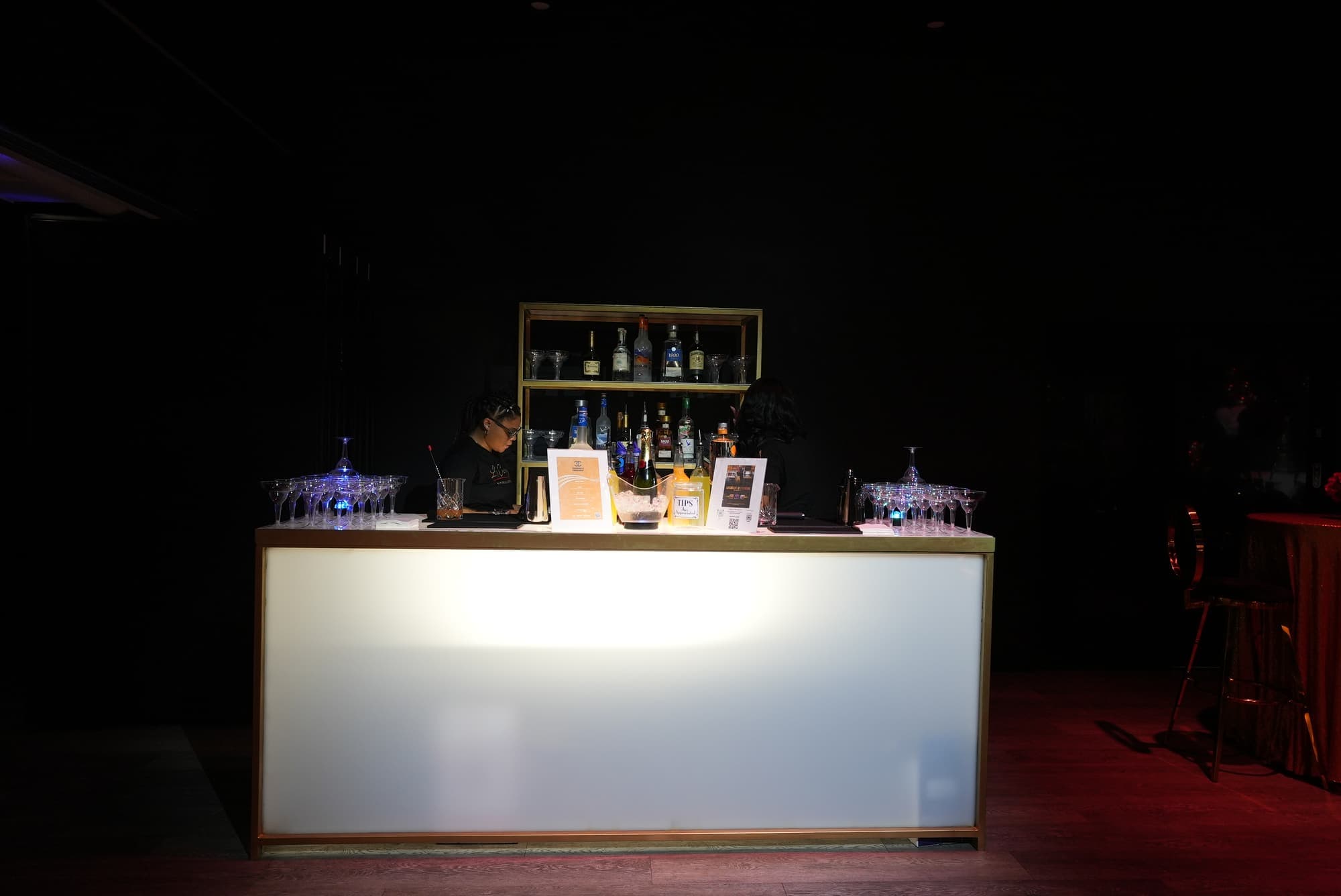 A lit white bar set up for a birthday