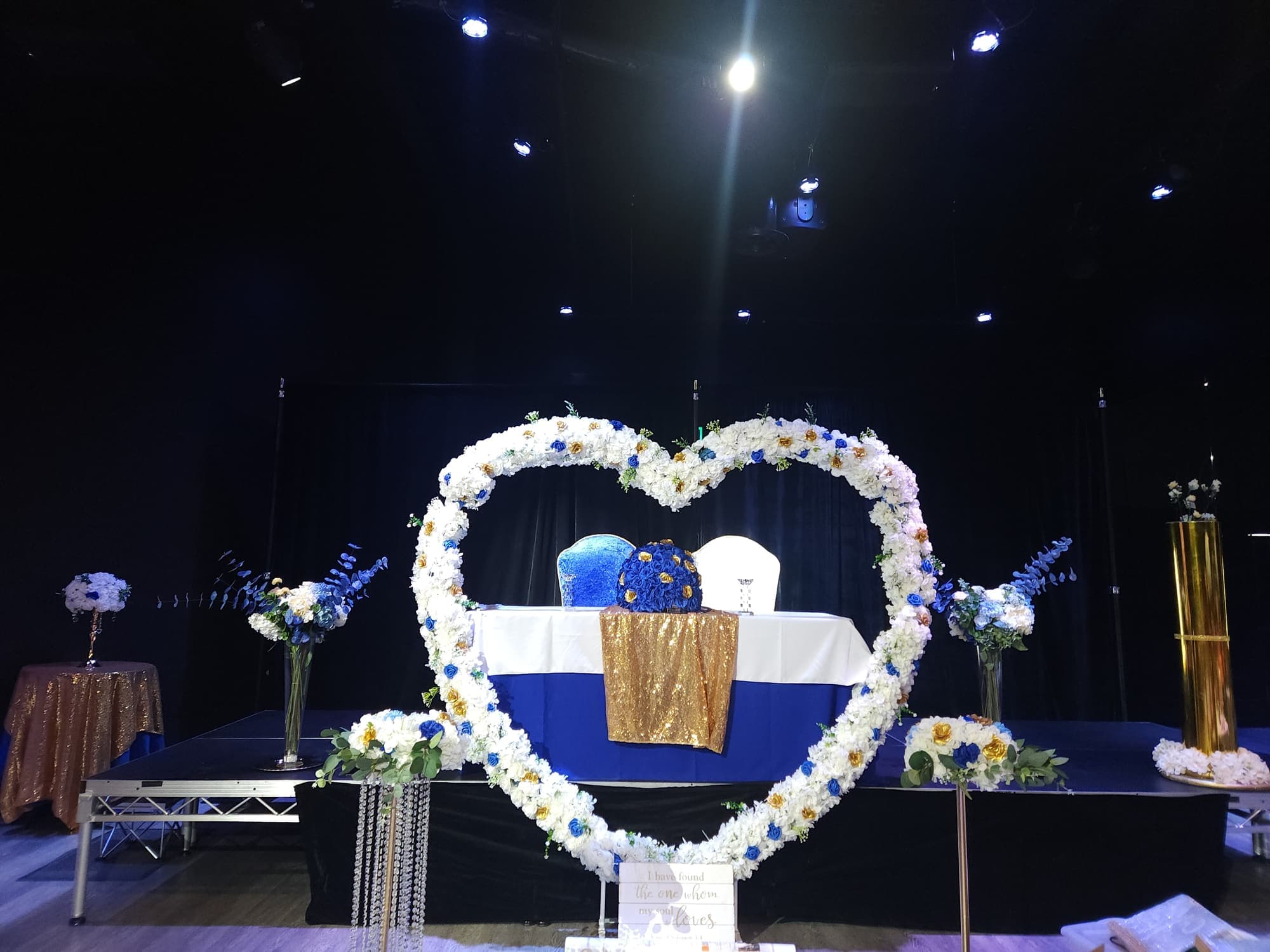 A floral heart arch over a sweetheart table