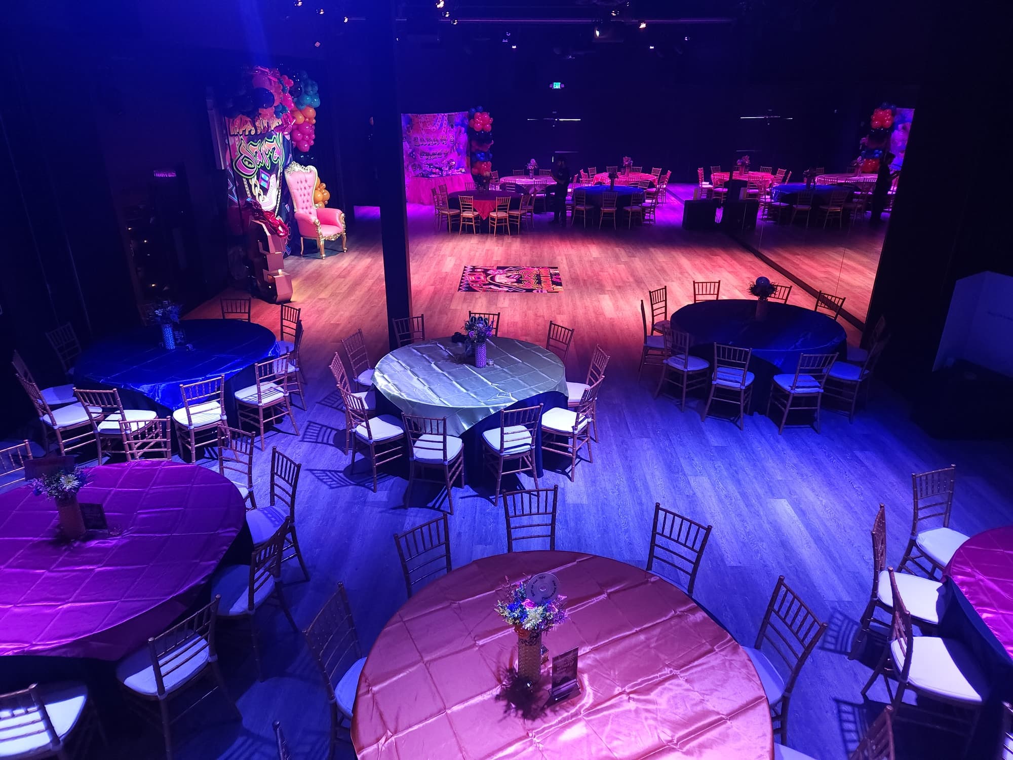 The hall set for a 30th birthday in pink and purple light