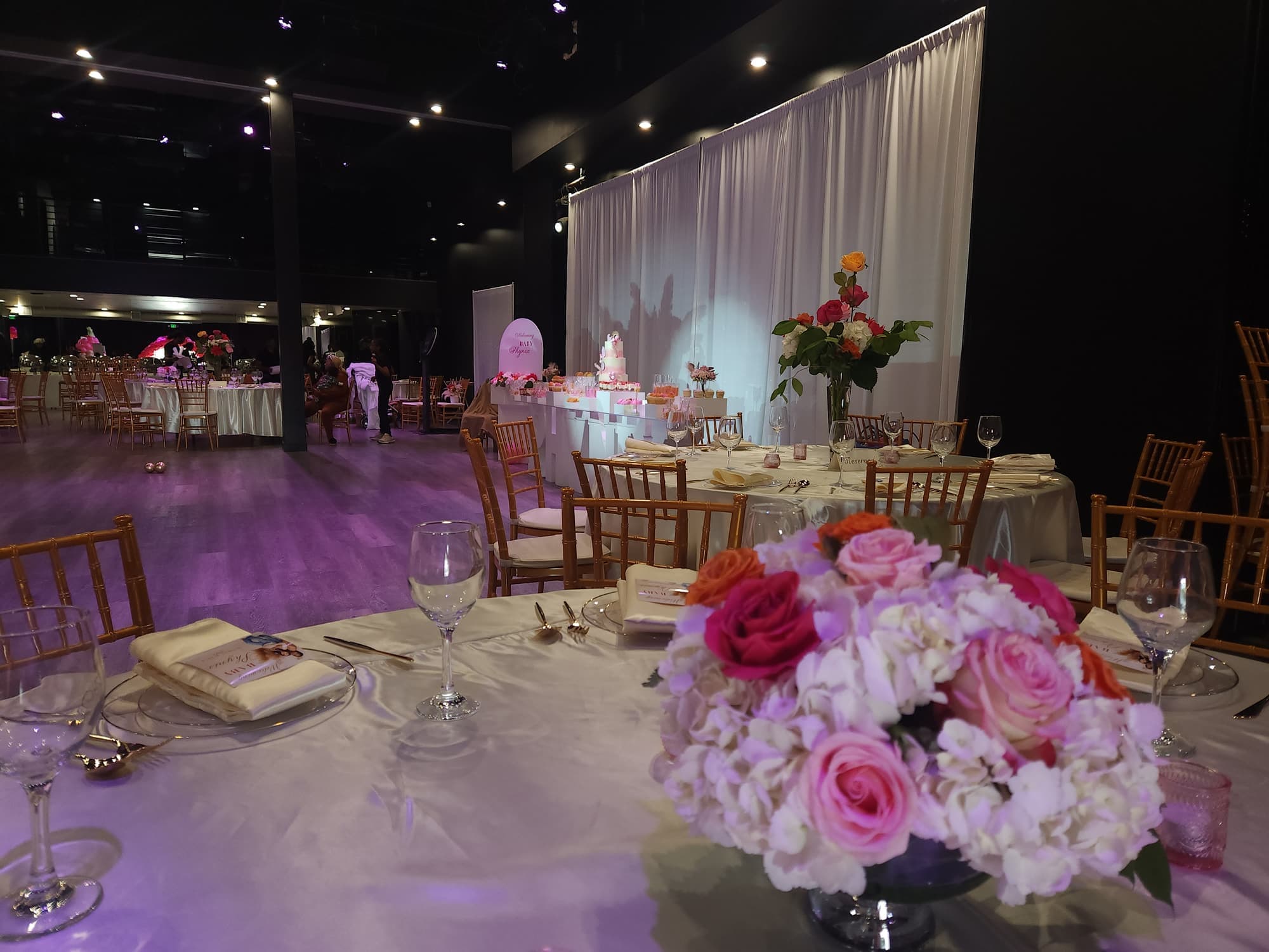 A shower table with pink roses and glassware