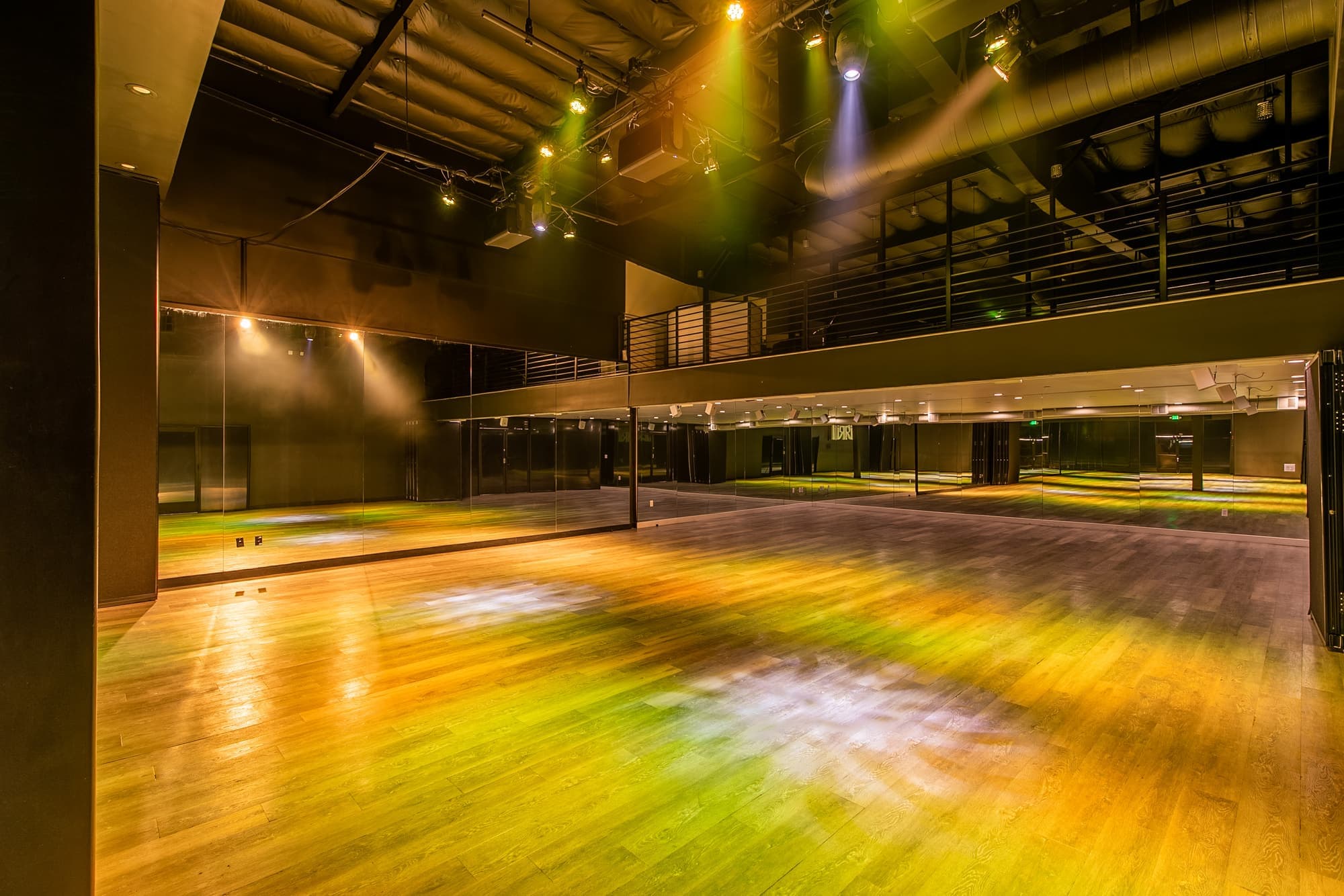 The full length of the main hall in gold light, seen from the stage end